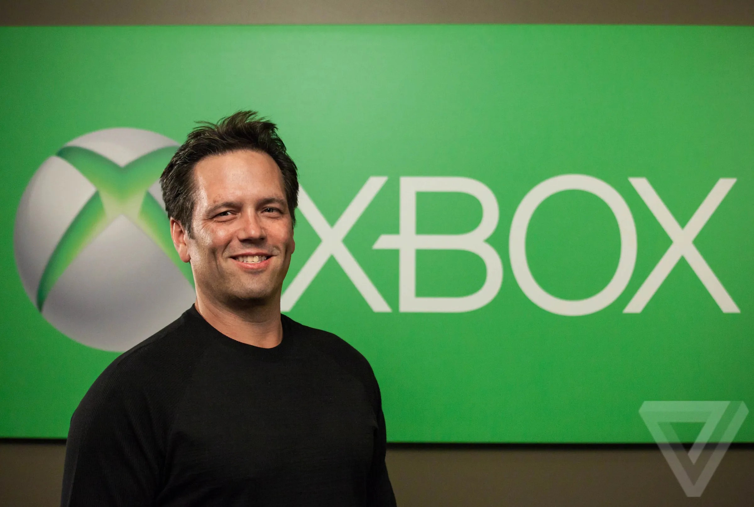 Phil Spencer in front of Xbox logo
